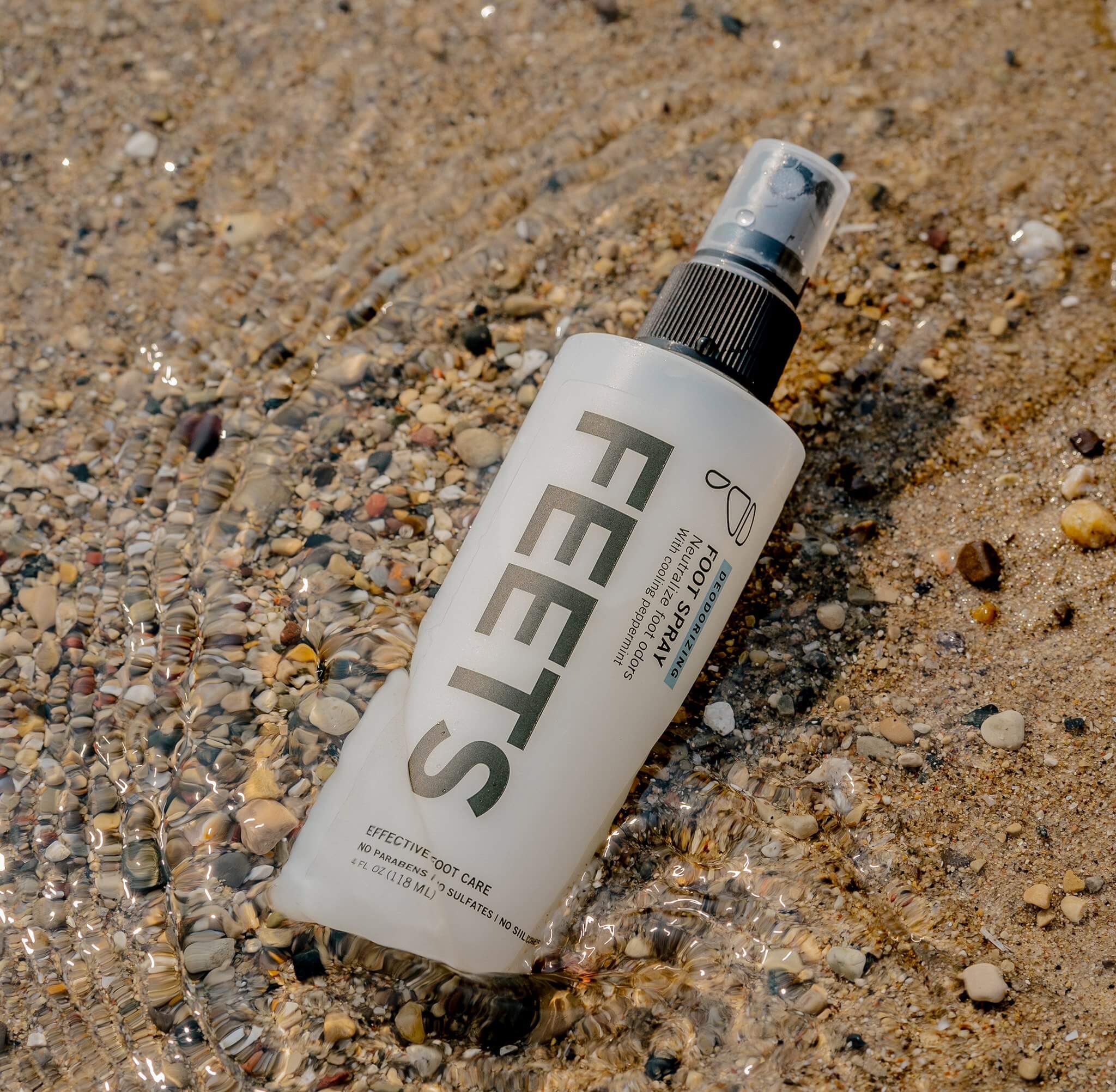 Foot and shoe spray on beach